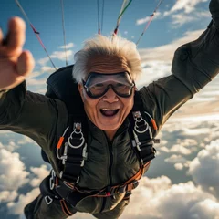 Tuinposter Thrill-seeker embraces freedom as he soars through the clouds in tandem skydiving, grinning from ear to ear and clad in protective gear and sunglasses © Dejan