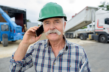 senior manual worker calling on the phone