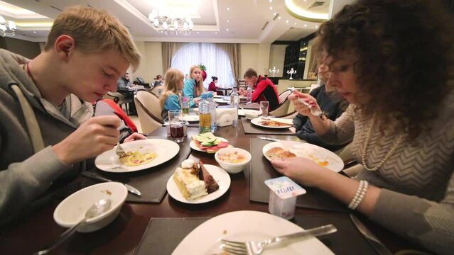 People of six eat breakfast in the buffet of the Hotel National