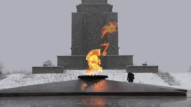 Eternal fire and Mother Armenia monument at winter overcast day
