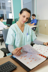 medical secretary looking through folder
