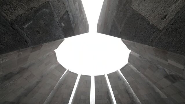 Truncated cone of twelve large stone slabs and eternal fire in memorial complex