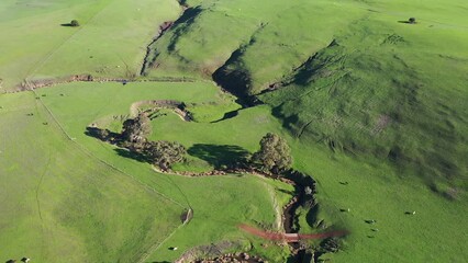 sunset over rolling hills on a farm and ranch in spring. flying over a sustainable farm, storing soil carbon. storing carbon and Carbon sequestration 