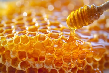 Close-up of honeycomb and honey spoon. Creative food background. Shallow depth of field. - obrazy, fototapety, plakaty