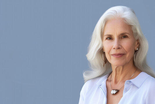 Senior Woman Posing In Front Of Flat Wall