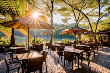 Outdoor restaurant patio with empty tables and umbrellas by a tranquil lake surrounded by greenery, basking in the warm morning sunlight.