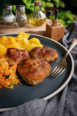 Meatballs  served with fired potatoes.