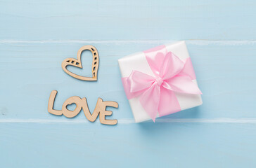 Valentines day composition with gifts on wooden background, top view.