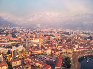 Drone shot of the city of Lecco city and Basilica di San Nicolò, Italy. Mount Resegone in the background