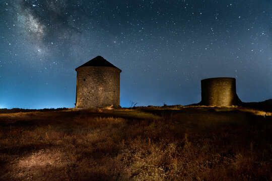 Traditional stone windmills with our milki way in the background