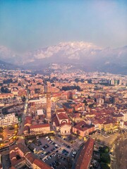 Drone shot of the city of Lecco city and Basilica di San Nicolò, Italy. Mount Resegone in the background