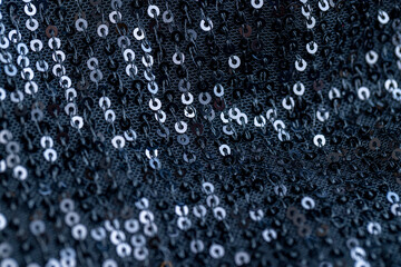 a large number of sequins on a black material