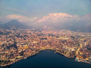 Panoramic shot of the city of Lecco and Lake Como at dusk, Italy. Mount Resegone in the background