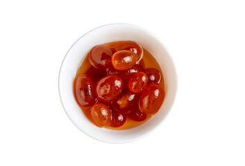 Homemade kumquat jam in jar and fresh kumquats, top view