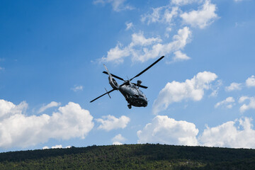 Military dauphin helicopter flying in the air.