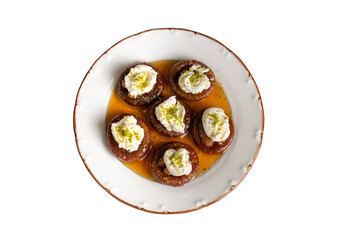 Stuffed dry fig dessert, cooked with syrup, traditional, pistachio and kaymak (Turkish name; kaymakli incir tatlisi )