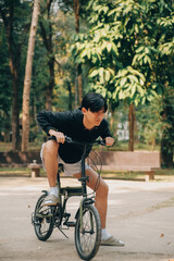 Handsome happy young man with bicycle on a city street, Active lifestyle, people concept