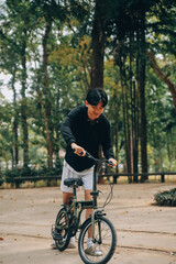 Fototapeta premium Handsome happy young man with bicycle on a city street, Active lifestyle, people concept