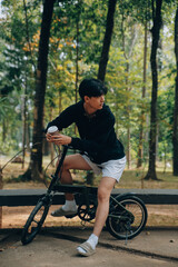 Obraz premium Handsome happy young man with bicycle on a city street, Active lifestyle, people concept