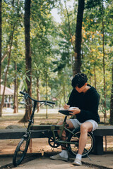 Fototapeta premium Handsome happy young man with bicycle on a city street, Active lifestyle, people concept