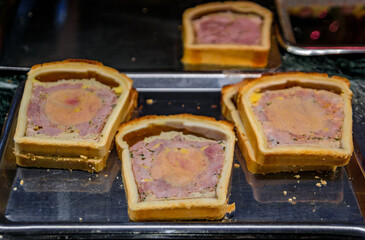 Foie gras or duck liver pate in a pastry, meat pie at a farmers market at an artisanal bakery in the historic center of Strasbourg, Alsace, France