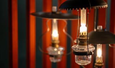 Vintage oil lamp lanterns source of light hanging in dark interior