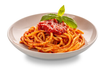 Bucatini pasta with tomato sauce and basil leaves in white plate isolated