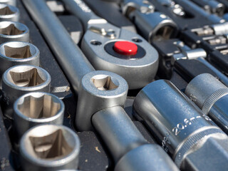 Close-up of various tools for car repair or other household needs. A set of tools, bits, screwdrivers, keys