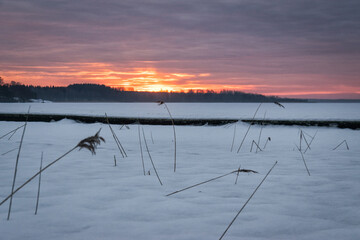 Beautiful sunrise over the frozen lake - 725019403