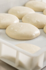 Fototapeta na wymiar Close up of round dough pieces for pizza preparation