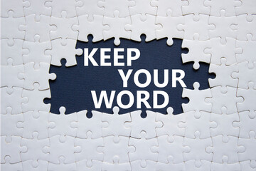 Keep your word symbol. Concept words Keep your word on white puzzle. Beautiful deep blue background. Business and Keep your word concept. Copy space.