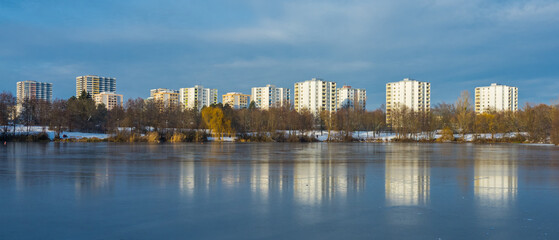 Winter panorama of cityscape by frozen lake