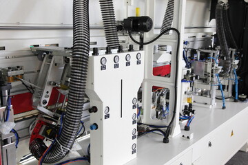 Modern CNC woodworking machine rear view with ventilation system pipe and air pressure manometers...