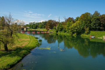 The Pjesacki Pontonski Most bridge spans the Kosana River as it passes through Karlovac in central Croatia. Early September