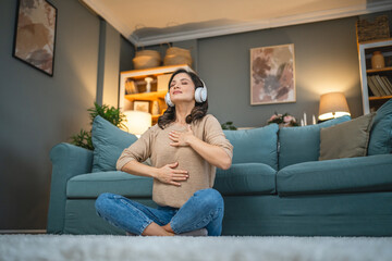 Obraz premium adult woman practice guided yoga meditation at home