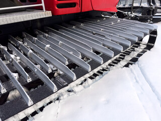 Snowcat machine for snow removal. Preparation ski trails. Snow groomer. Snowy tracks of snowcat in...