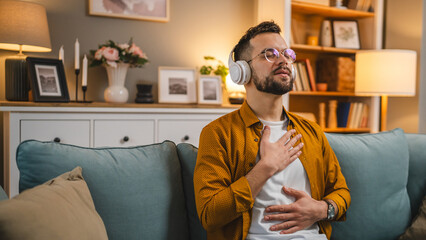 man with headphones practice guided meditation yoga self care at home - obrazy, fototapety, plakaty