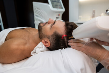 Customer in a beauty clinic having anti hair loss procedures