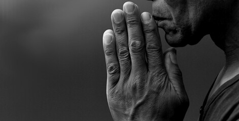  black man praying to god with black grey background with people stock image stock photo - Powered by Adobe