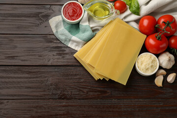 Ingredients for lasagna on wooden table, flat lay. Space for text
