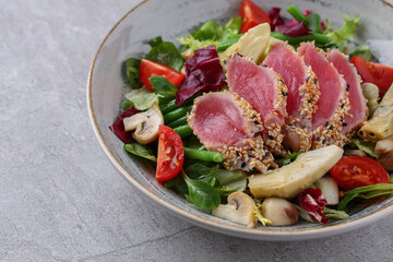salad with carpaccio, artichoke and asparagus on a stone background, studio food photography 3