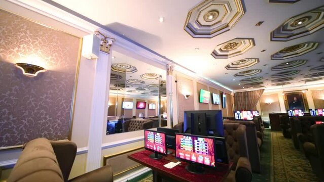 Rows of computers and armchairs in Bingo Boom bookmaker club 
