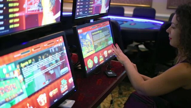 Woman playing on computer in Bingo Boom bookmaker club