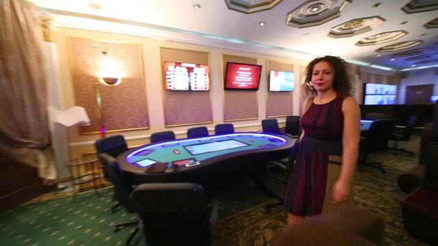Woman gets up from table and walks around game room in Bingo Boom bookmaker club
