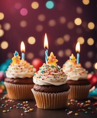 Birthday cupcakes with celebration candles and sprinkles for a birthday party, copy space for text

