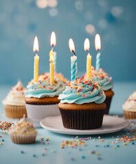 Birthday cupcakes with celebration candles and sprinkles for a birthday party, copy space for text

