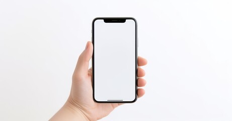 Hand holding smartphone with blank screen in minimalist setting, highlighting connectivity and technology