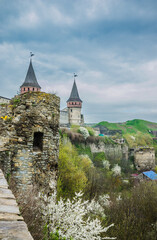 Old Kamianets-Podilskyi Castle under the cloudy sky. Part of the powerful bastions of the castle....