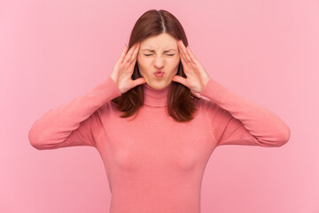 Unhealthy sick ill attractive woman with brown hair touches temples has unbearable headache suffers...