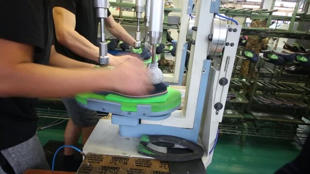 Male hands spin shoe in Ralf Ringer factory. 